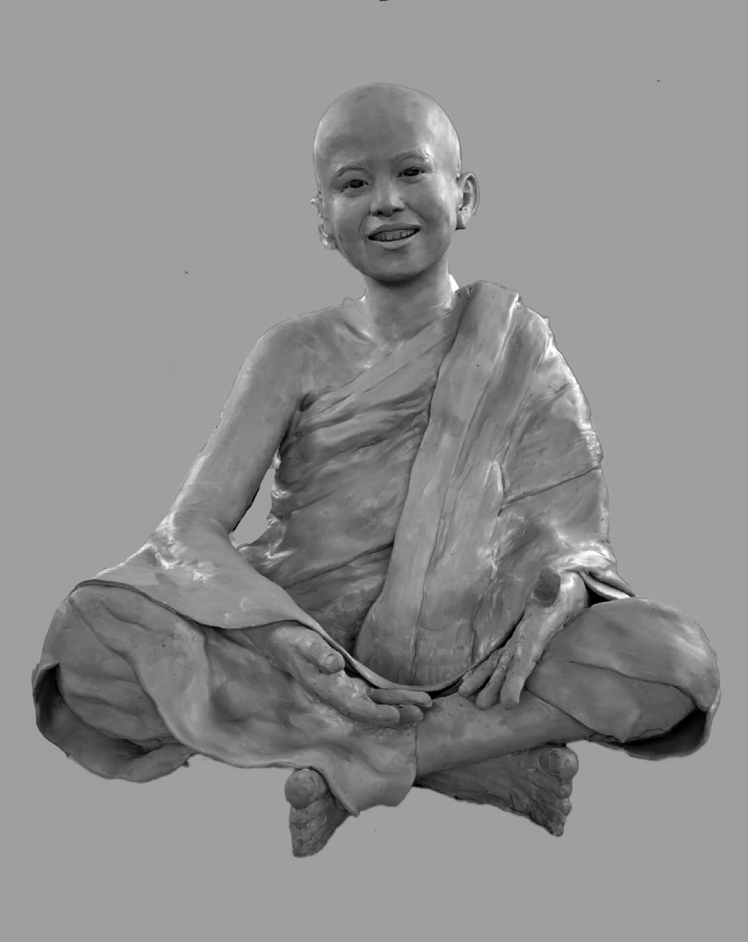 Seated figure — serene smile, grey patina